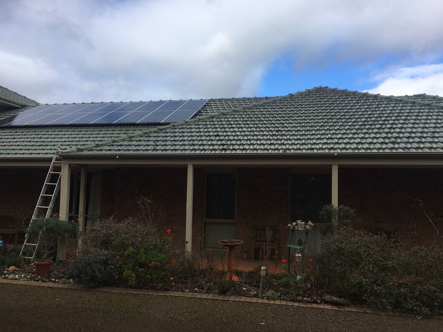 Restored red tiled roof on a weatherboard home